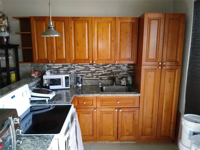 a stove top oven sitting inside of a kitchen