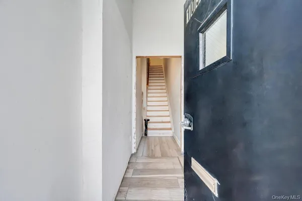 a view of a hallway with wooden walls and entryway