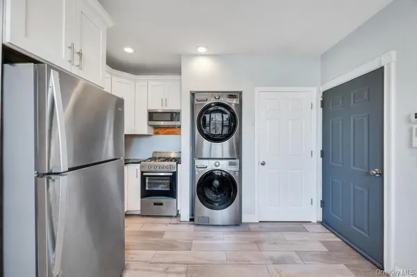 a kitchen with a refrigerator a washer and dryer