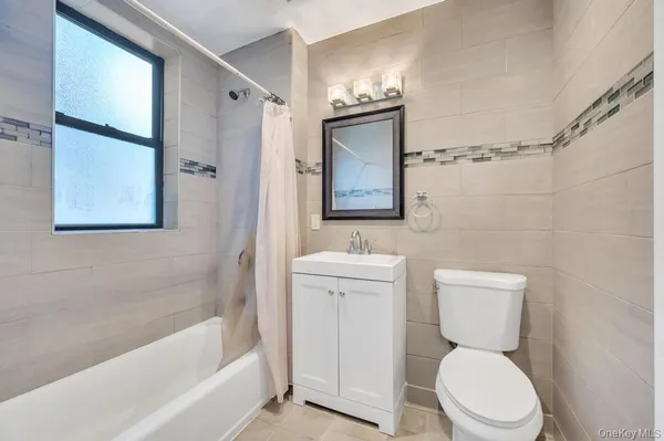 a white toilet sitting next to a bath tub shower