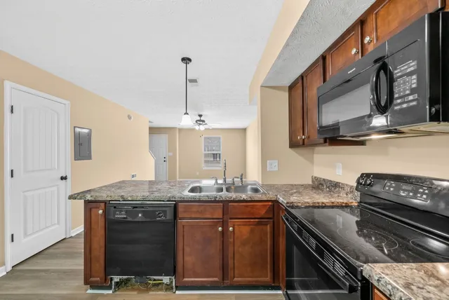 a kitchen with stainless steel appliances granite countertop a stove and a sink