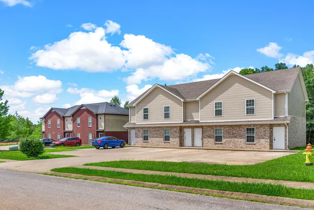 a front view of a house with a garden and plants