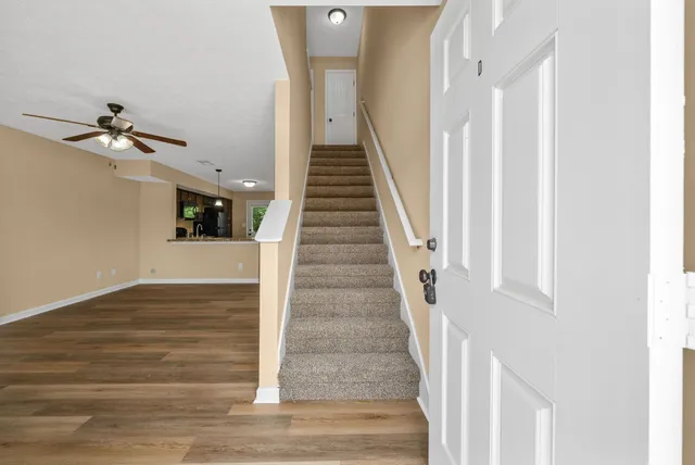a view of entryway and hall with wooden floor