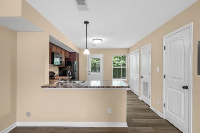 a view of living room with granite countertop furniture and fireplace