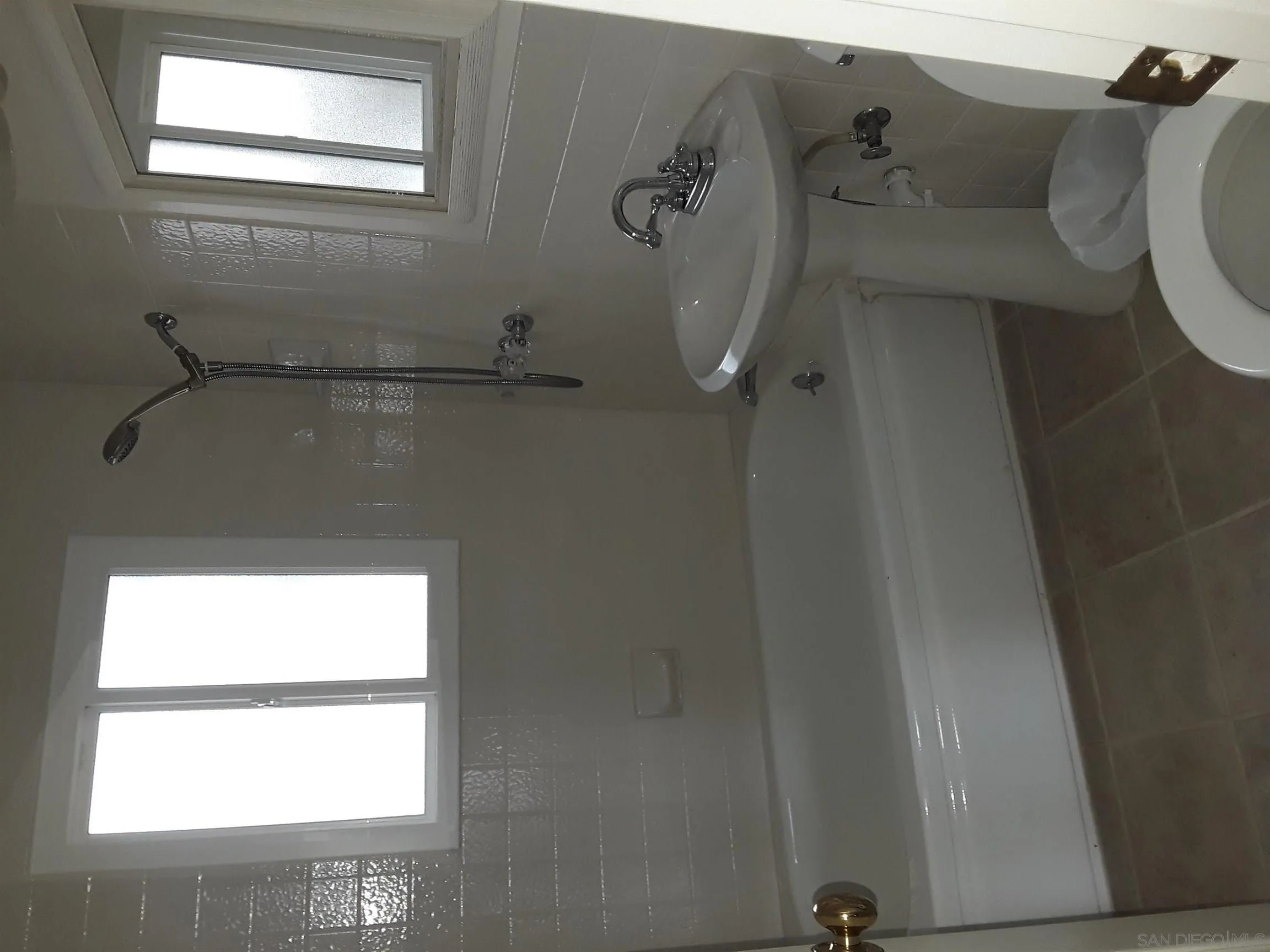 5142 Providence Road San Diego, CA 92117 - Photo 13 of 18 a bathroom with a window a toilet and a shower