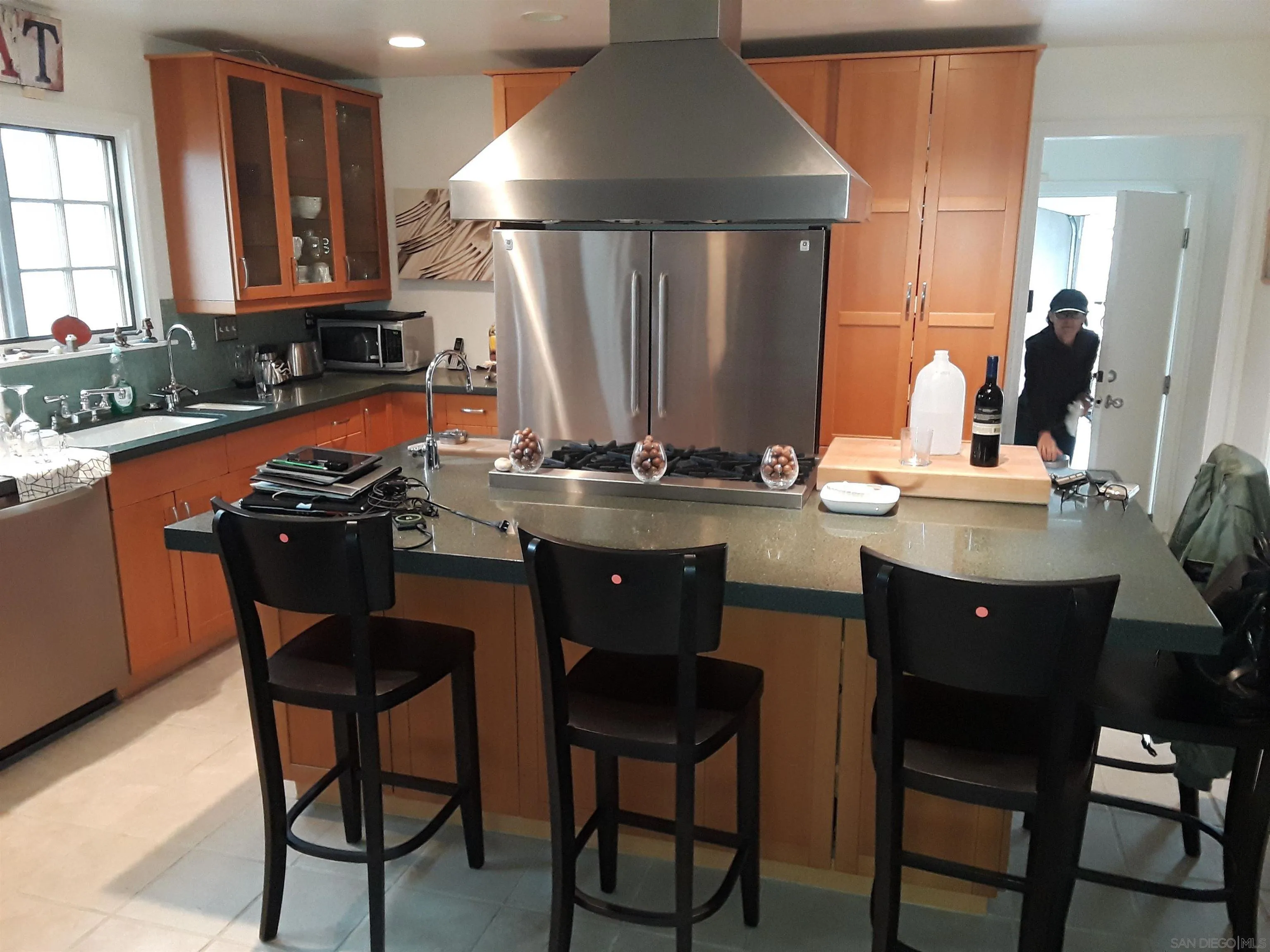 5142 Providence Road San Diego, CA 92117 - Photo 2 of 18 a kitchen with stainless steel appliances granite countertop a sink a stove a table and chairs