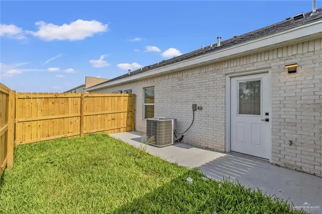 a view of a backyard with wooden fence