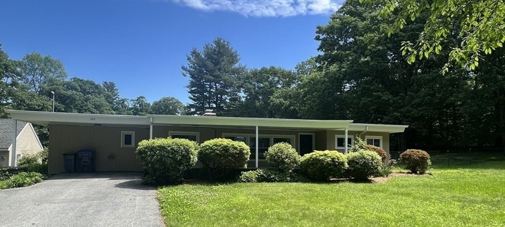 a view of house with backyard and garden