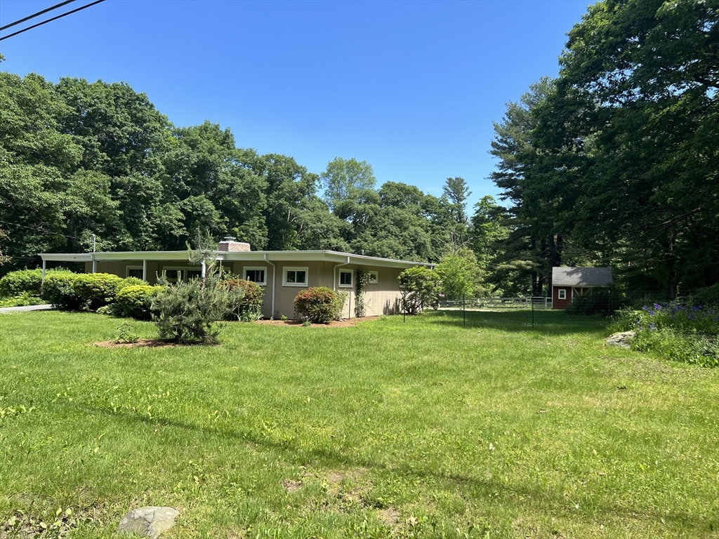 172 Brigham Hill Road Grafton, MA 01536 - Photo 2 of 15 a view of a house with a big yard potted plants and large trees
