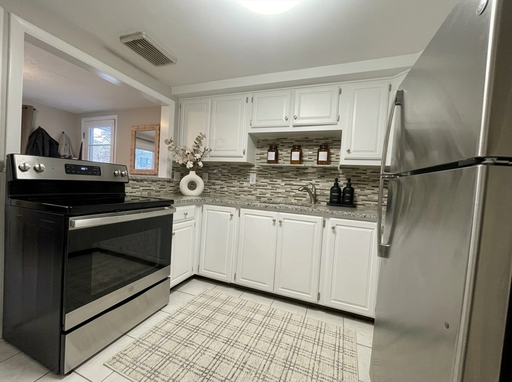 172 Brigham Hill Road Grafton, MA 01536 - Photo 7 of 15 a kitchen with cabinets and stainless steel appliances