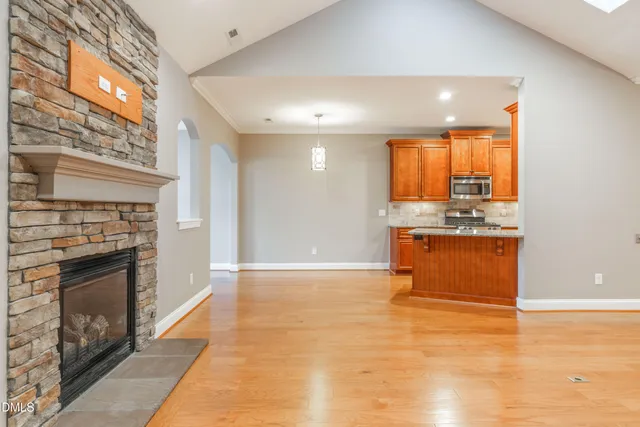 a view of a kitchen with a sink and a fireplace