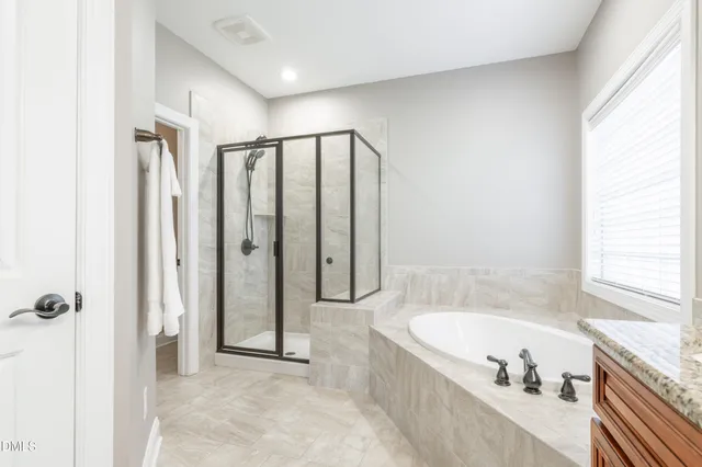 a bathroom with a bathtub and a shower