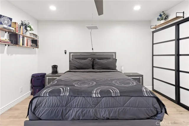 a bedroom with a bed and wooden floor