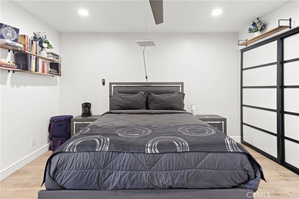 7740 Redlands Street Playa del Rey, CA 90293 - Photo 12 of 14 a bedroom with a bed and wooden floor