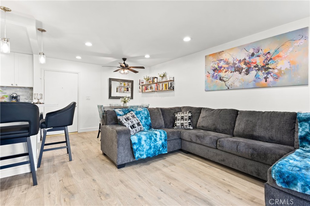 7740 Redlands Street Playa del Rey, CA 90293 - Photo 6 of 14 a living room with couches a coffee table and kitchen view with wooden floor