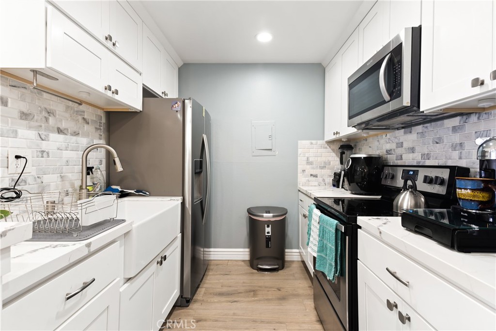 7740 Redlands Street Playa del Rey, CA 90293 - Photo 8 of 14 a kitchen with stainless steel appliances granite countertop a sink stove and refrigerator