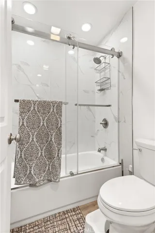 a bathroom with a toilet and a shower