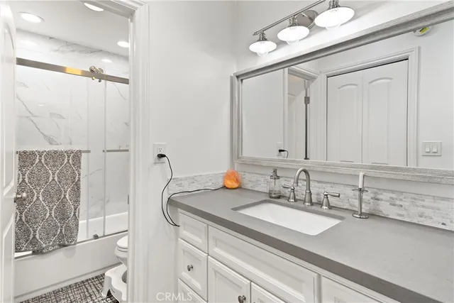 a bathroom with a sink double vanity and a mirror