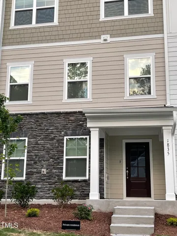 a view of a brick house with a large windows