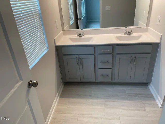 a bathroom with a sink a vanity and a mirror