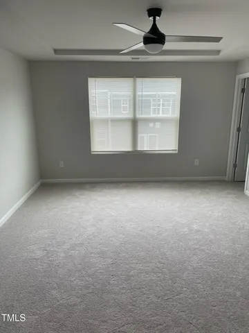 an empty room with a empty space and windows