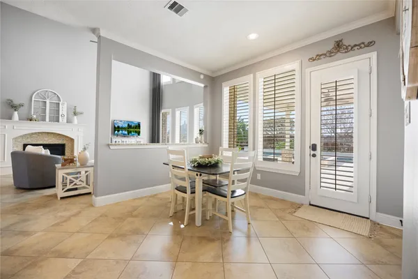 a dining room with furniture and window