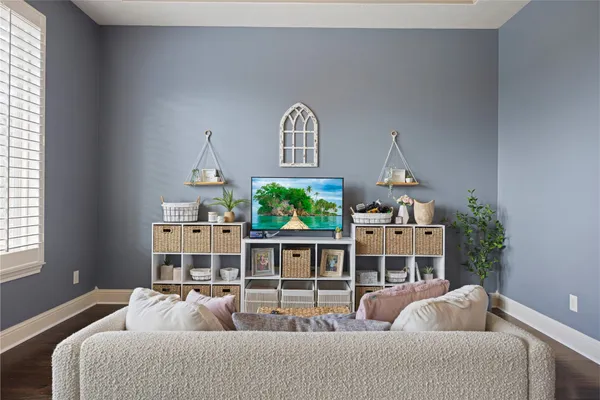 a living room with furniture a rug and a window