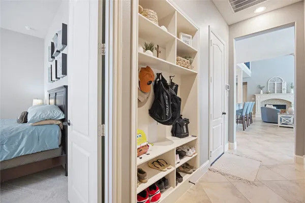 a view of walk in closet with clothes and shoes
