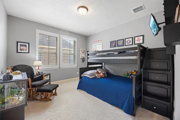 a bedroom with furniture and a window