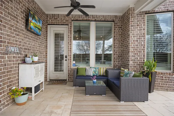 a building outdoor space with patio furniture and potted plants