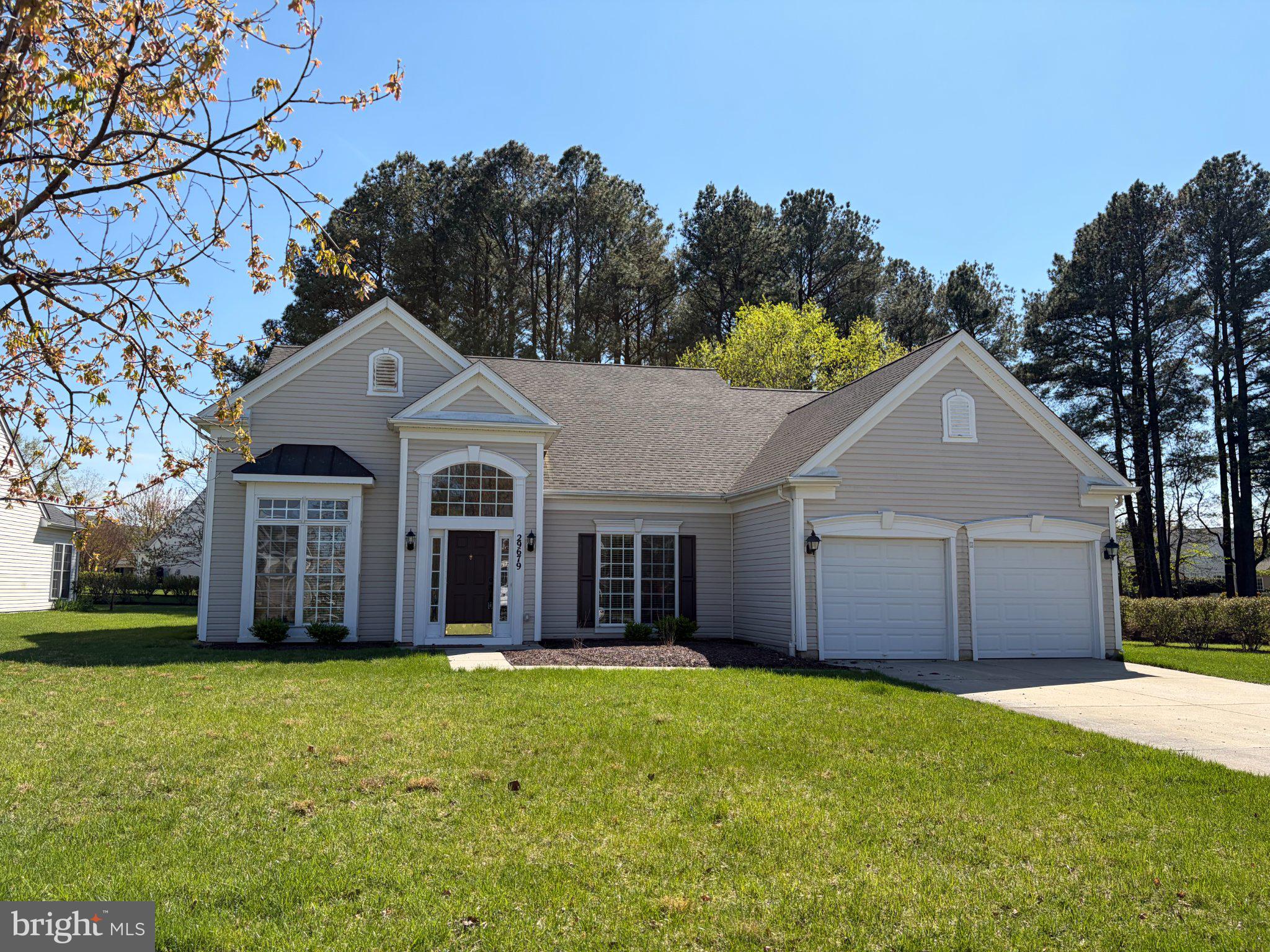 29679 Janets Way Easton, MD 21601 - Photo 1 of 23 a front view of a house with a garden and yard