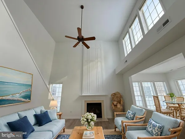 a living room with furniture fireplace and a window