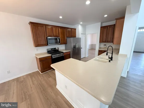 a kitchen with stainless steel appliances a sink stove and refrigerator