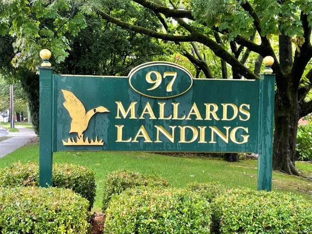 a street sign that is sitting in the middle of a park