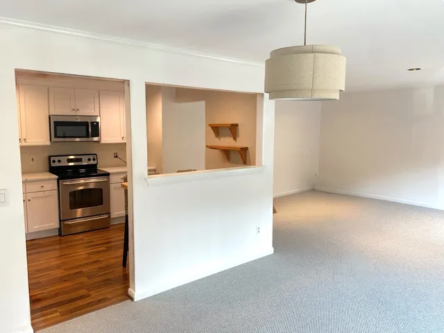 a view of a kitchen with a sink and a refrigerator