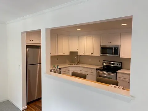 a kitchen with stainless steel appliances granite countertop a refrigerator sink and stove