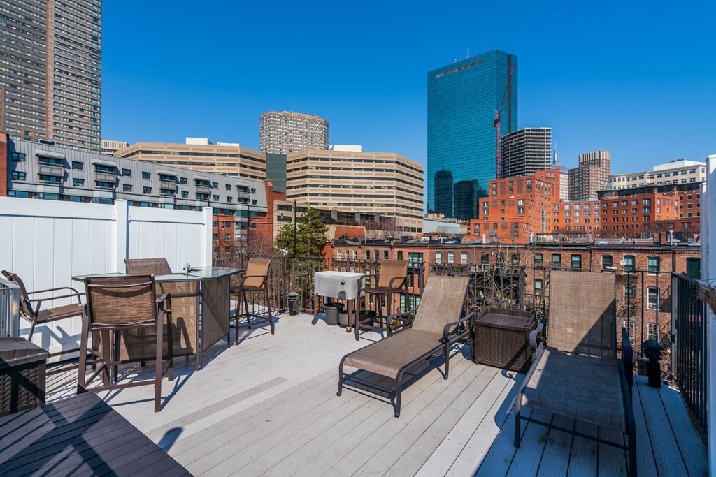 231 West Canton Street, Unit 4 Boston, MA 02116 - Photo 1 of 17 a view of a balcony with chairs and wooden floor
