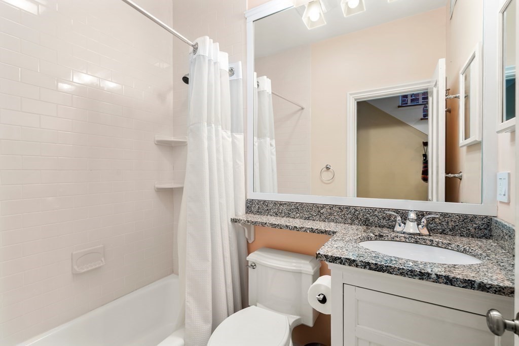 231 West Canton Street, Unit 4 Boston, MA 02116 - Photo 11 of 17 a bathroom with a granite countertop sink toilet and shower