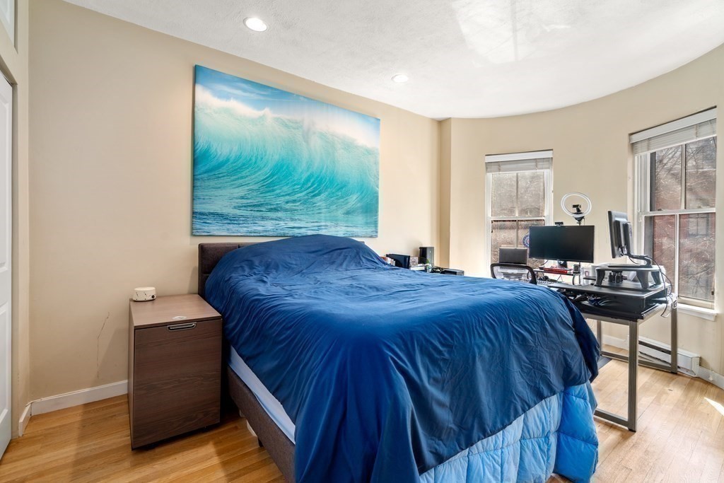 231 West Canton Street, Unit 4 Boston, MA 02116 - Photo 14 of 17 a bedroom with a bed and wooden floor