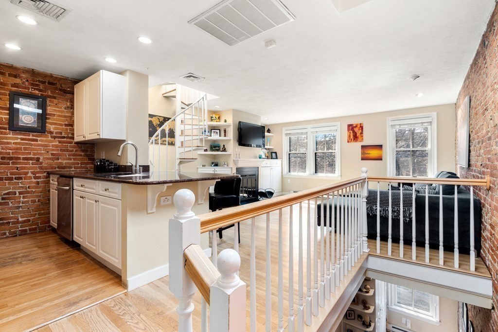 231 West Canton Street, Unit 4 Boston, MA 02116 - Photo 3 of 17 a kitchen with stainless steel appliances kitchen island granite countertop a stove a sink and a refrigerator