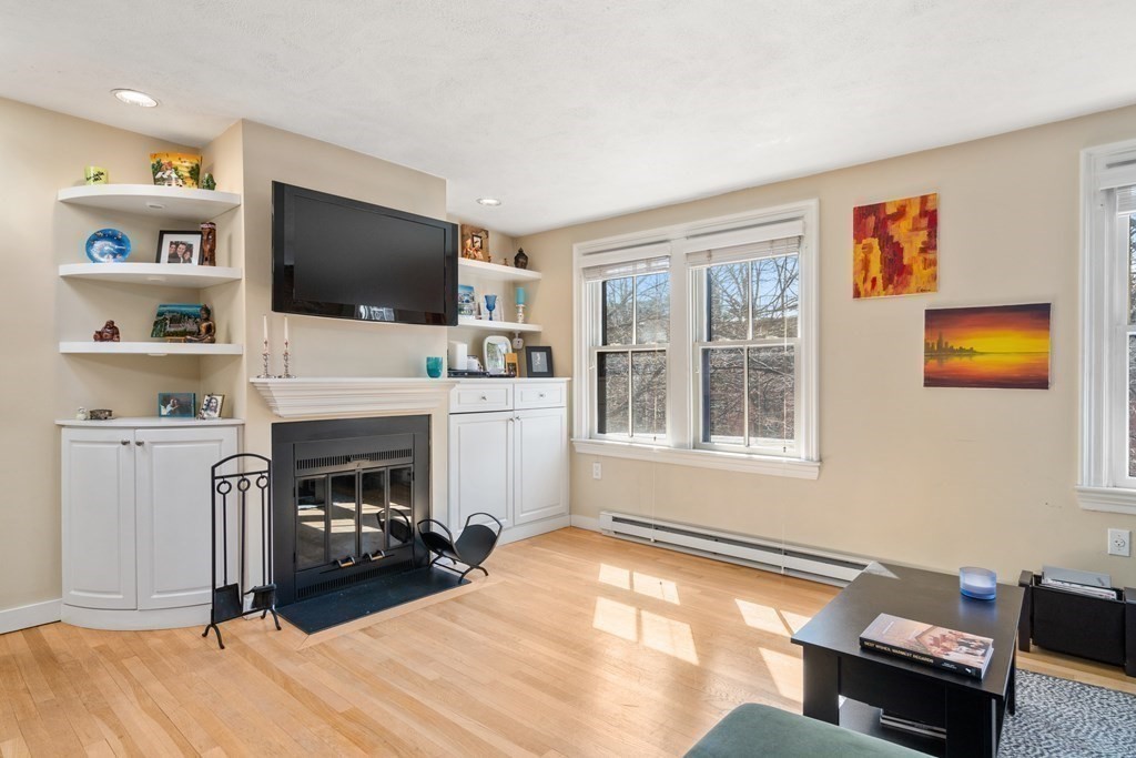231 West Canton Street, Unit 4 Boston, MA 02116 - Photo 5 of 17 a living room with furniture a flat screen tv and a fireplace