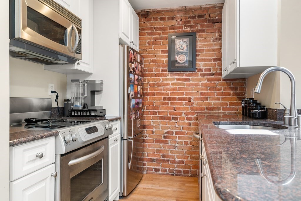 231 West Canton Street, Unit 4 Boston, MA 02116 - Photo 7 of 17 a kitchen with stainless steel appliances a stove and a microwave