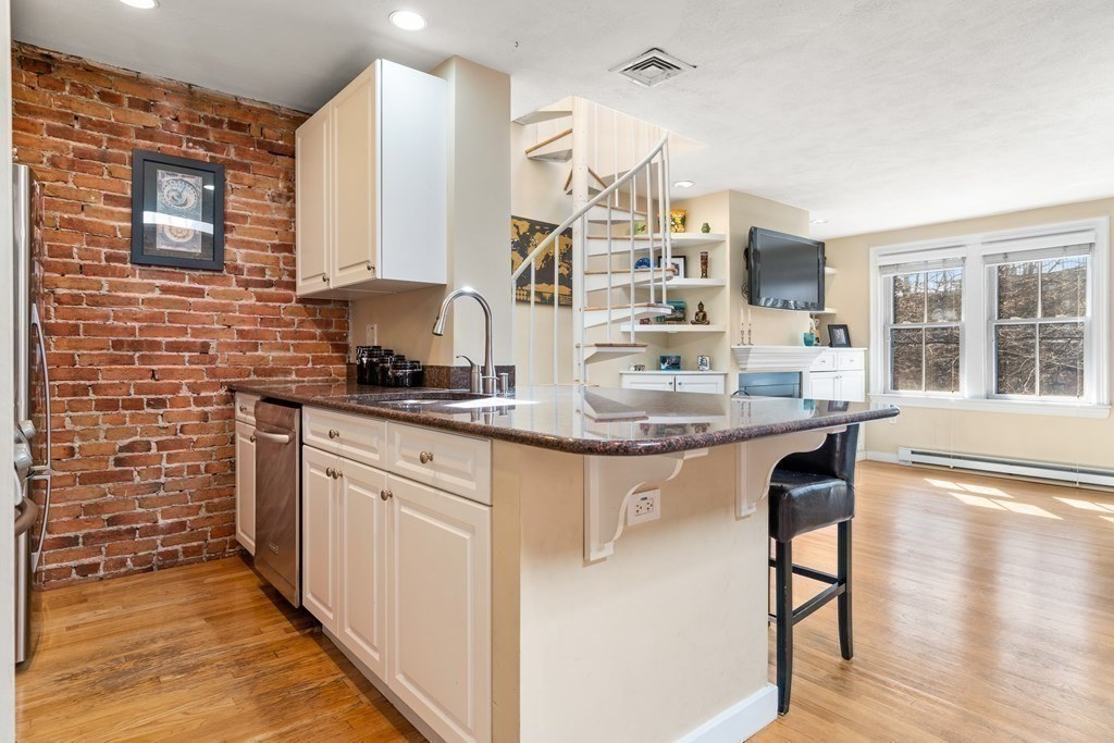 231 West Canton Street, Unit 4 Boston, MA 02116 - Photo 9 of 17 a kitchen with stainless steel appliances granite countertop a stove a sink and a refrigerator