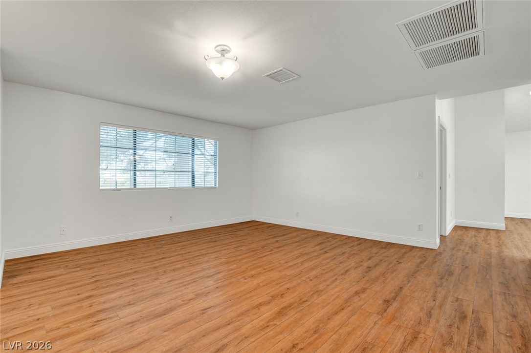1810 Pinto Road Henderson, NV 89002 - Photo 9 of 53 A generously proportioned room with durable laminate flooring and ample natural light from a well-placed window.