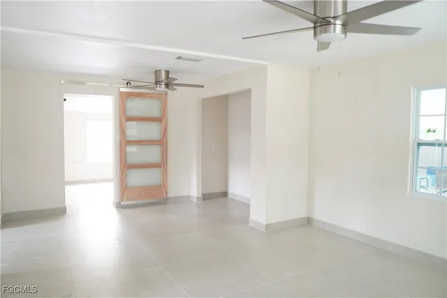 an empty room with windows and closet