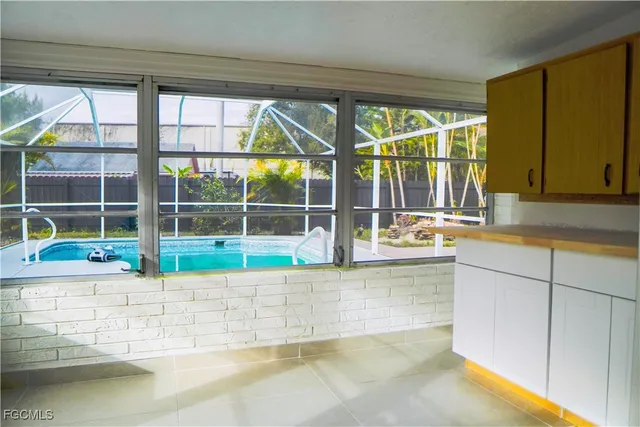 a view of a kitchen with a sink and a large window