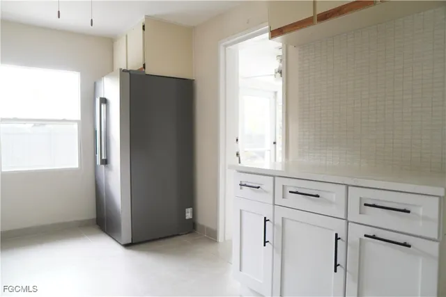 a view of cabinets with refrigerator and cabinet