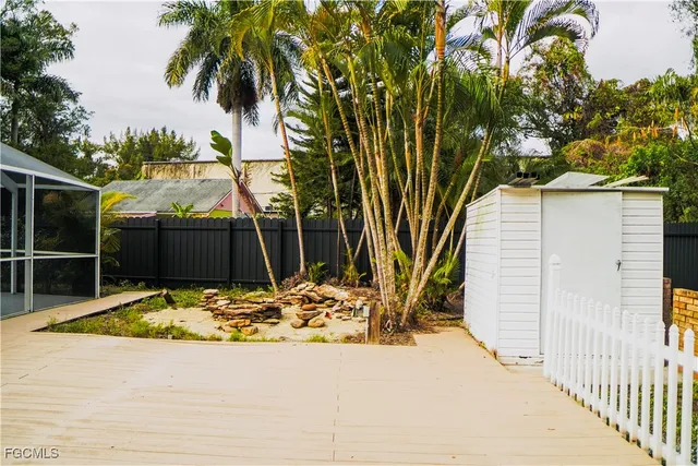 a view of a backyard with a large tree