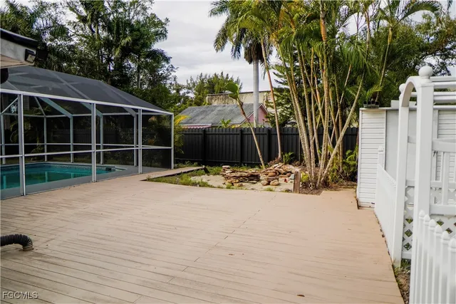 a view of a house with a yard and potted plants