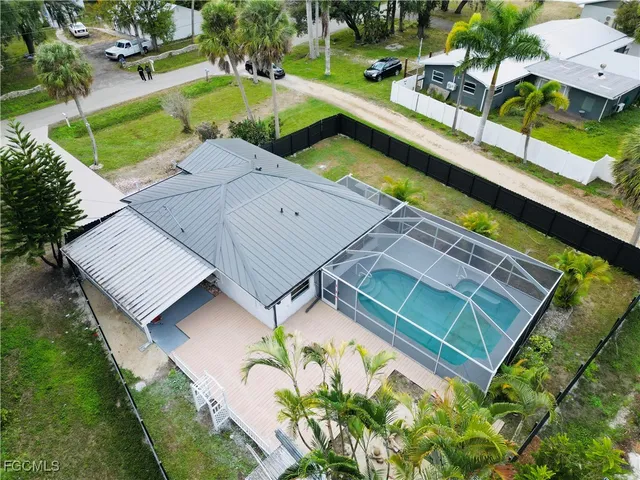 an aerial view of a house with a garden and swimming pool